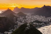 Rio's Sunset Charm: City and Mountains Under Orange Sky