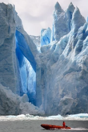 The Majesty of Icebergs: Ice Arches and the Colourful Boat