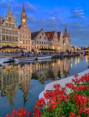 Evening Canal of Belgium: Historical Architecture and Floral Reflections