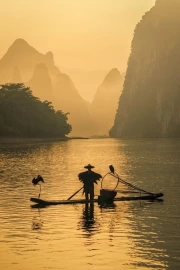 Fisherman on the River in China's Misty Morning: Harmony of the Eastern Mountains