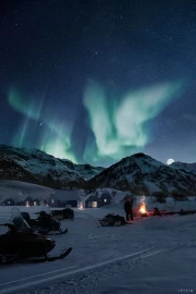 Northern Lights over Finland's Snowy Huts