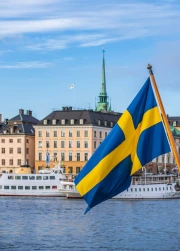 Sweden: Bright Flag Over Calm Cityscape