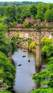 Arch Bridge and Boats: The Charm of the British Landscape