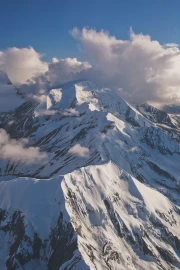 Alaska's Grandeur: Snowy Mountains and Clouds USA