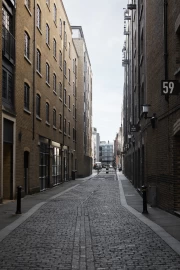 Urban Symphony: Narrow Street Between Brick Buildings
