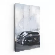 Black Mustang Against Concrete Wall - Power and Elegance