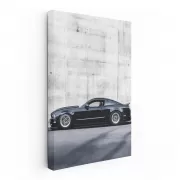 Black Mustang Against Concrete Wall - Bold and Powerful