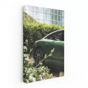 Sleek Green Porsche Parked by Glass Building - Style Meets Speed